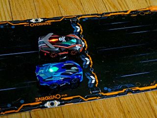 The two default Anki Overdrive cars, Skull (black) and Ground Shock (blue).