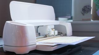 Cricut Maker 4 cutting machine making projects with basswood and cardstock