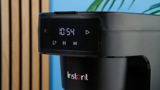 A black Instant Infusion Brew 12-Cup drip coffee maker with a removable water reservoir, glass carafe and reusable coffee filter