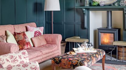 Snug room ideas with dark walls wood-burner and plush chairs sims hilditch