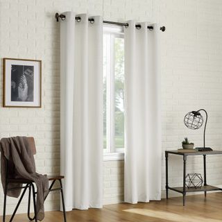 white blackout curtains to the floor with white brick industrial style room