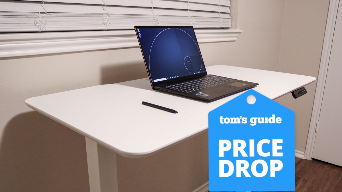 The Vari Essential electric standing desk with a Tom&#039;s Guide Price Drop deals badge