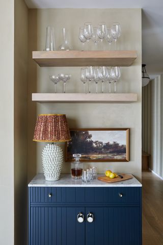 Open shelving with glassware displayed on each shelf