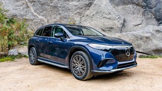 Mercedes EQS SUV parked outdoors in woods