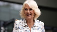 Queen Camilla smiling as she attends Wimbledon 2025 