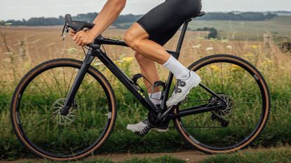 Image shows cyclist wearing one of the best gravel shoes 