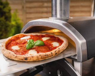 pizza being cooked in an Ooni Fyra pizza oven