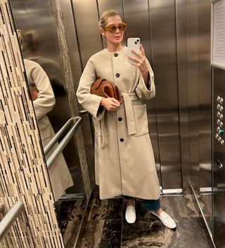 Kelly Rutherford wearing a collarless wool coat.