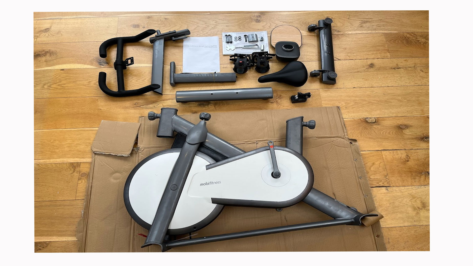 The image shows the Mobi Turbo exercise bike in parts.