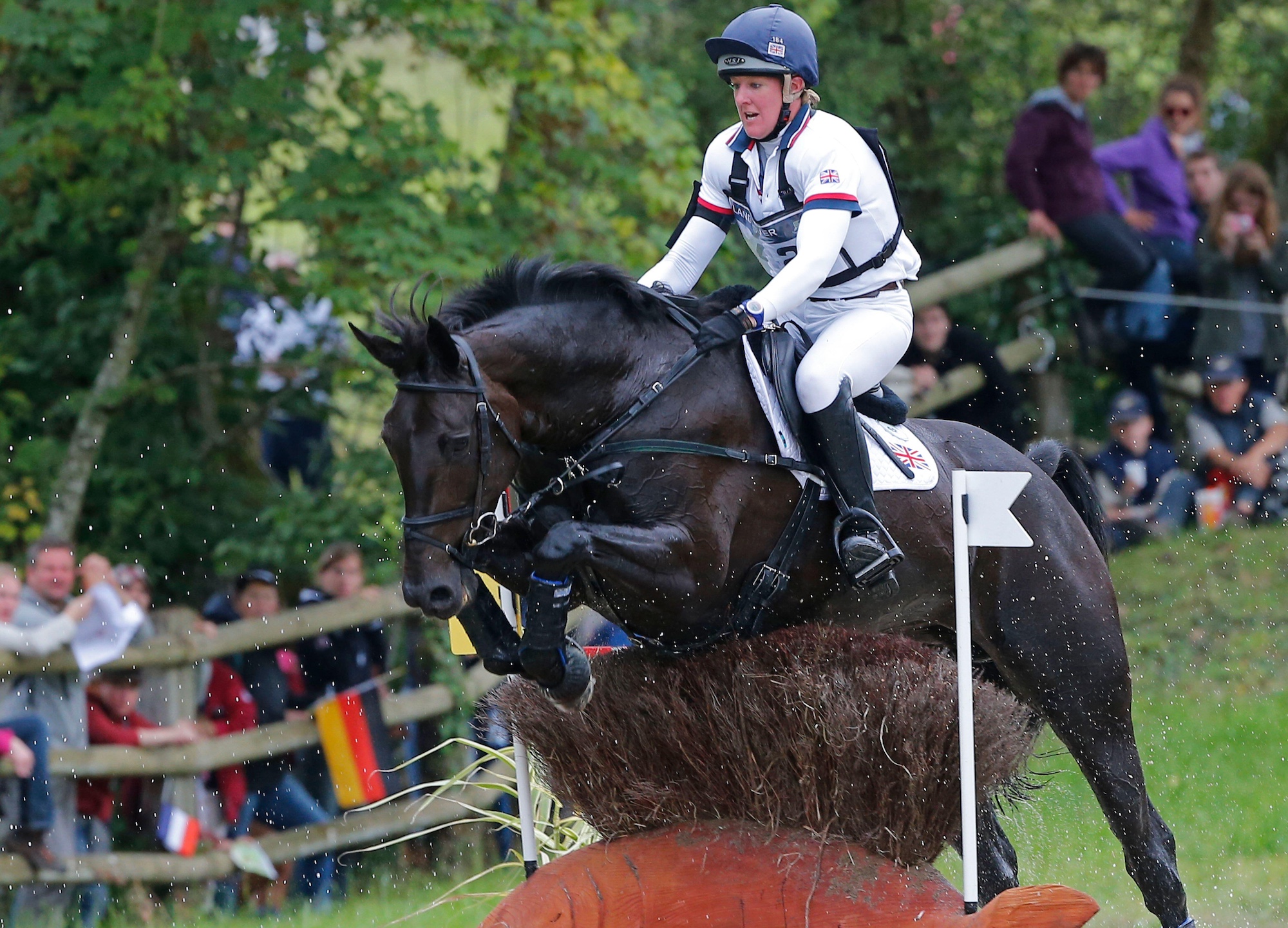 Annie Clover and Nicola Wilson at WEG 2014, jumping a skinny in wet conditions