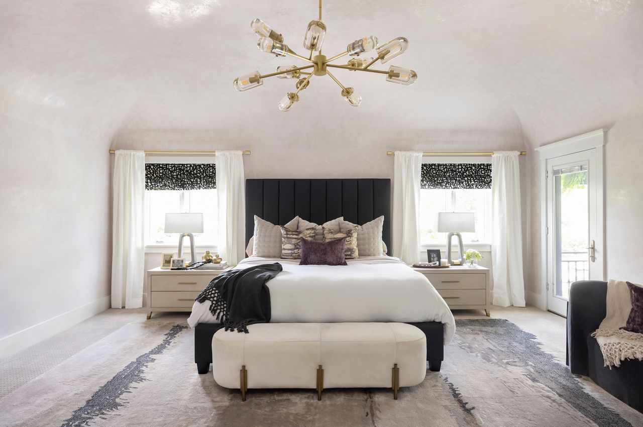 a luxury bedroom with carpet and two nightstands 