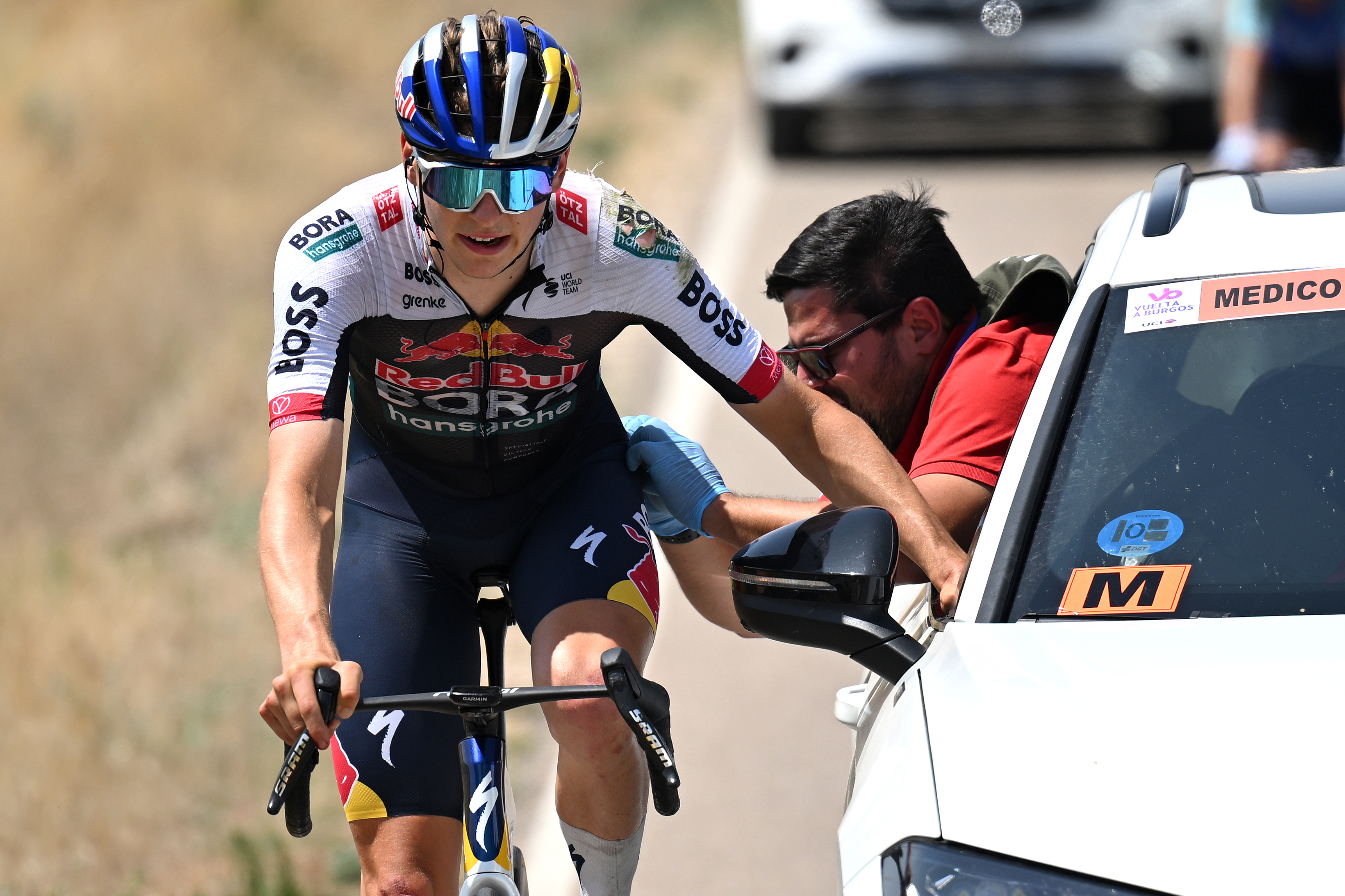 LAGUNAS DE NEILA, SPAIN - AUGUST 09: Emil Herzog of Germany and Team Red Bull - BORA - hansgrohe assisted by the medical car after being involved in a crash during the 47th Vuelta a Burgos 2025, Stage 5 a 138.3km stage from Quintana del Pidio to Lagunas de Neila 1866m on August 09, 2025 in Lagunas de Neila, Spain. (Photo by Antonio Baixauli/Getty Images)