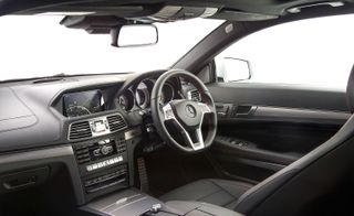 Black leather interior of the car, highlighted with red stitching