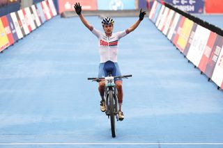MUNICH GERMANY AUGUST 19 Tom Pidcock of Great Britian crosses the line to celebrate winning gold in the Mens CrossCountry during the cycling Mountain Bike competition on day 9 of the European Championships Munich 2022 at Olympiapark on August 19 2022 in Munich Germany Photo by Alexander HassensteinGetty Images