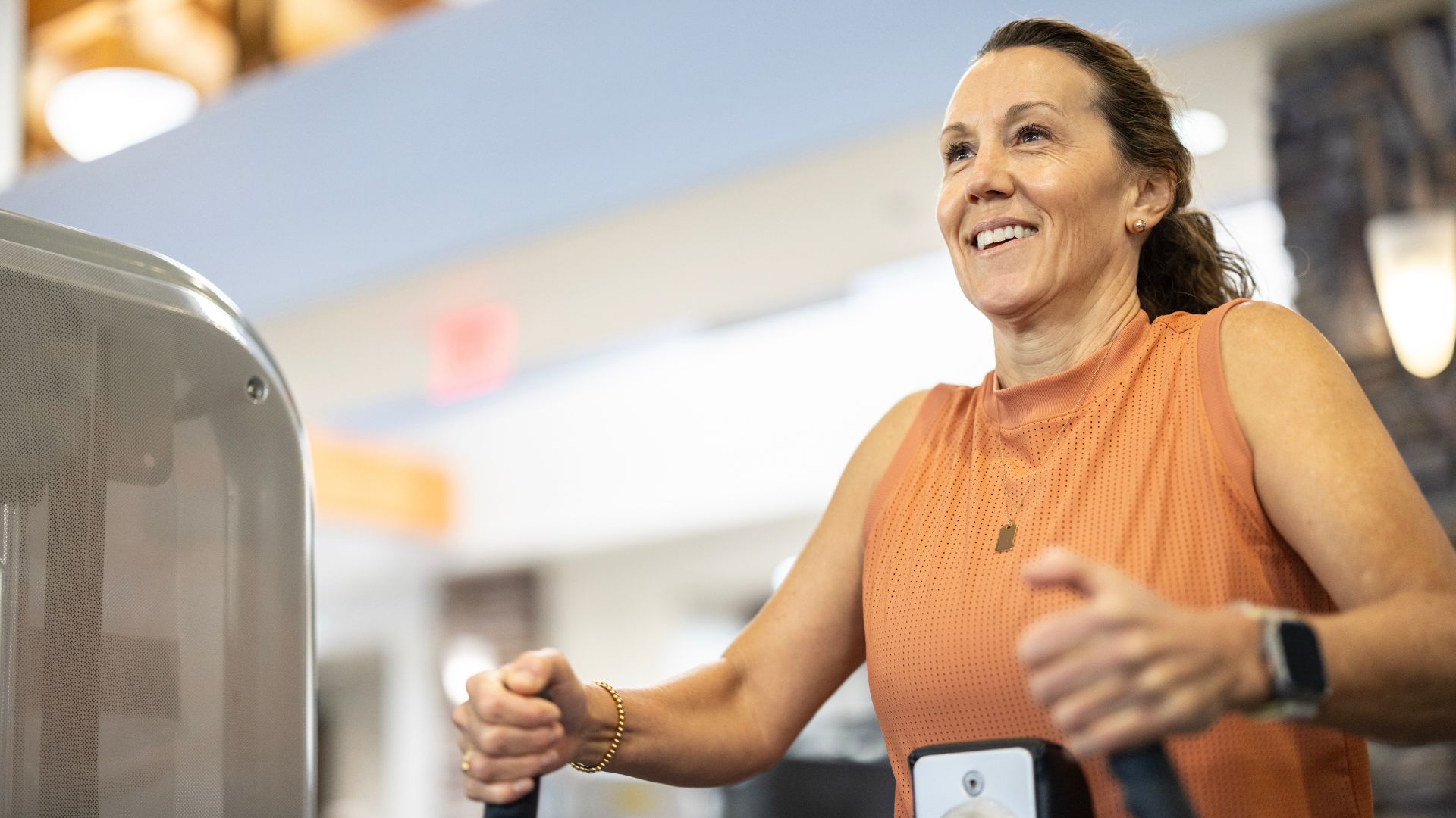 Woman using machines in the gym for back exercise