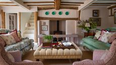country living room with pink walls and patterned furnishings