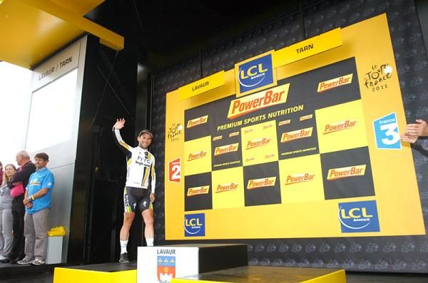 Mark Cavendish steps onto the podium following his win in stage 11.