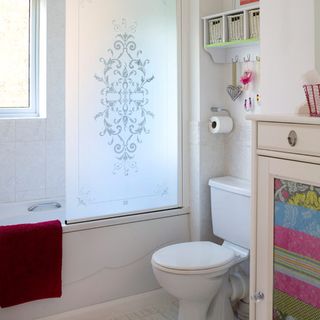 bathroom with glass door and towel with commode
