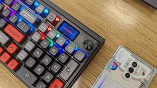 RedMagic 8 Pro and Mechanical Keyboard on a wooden desk.