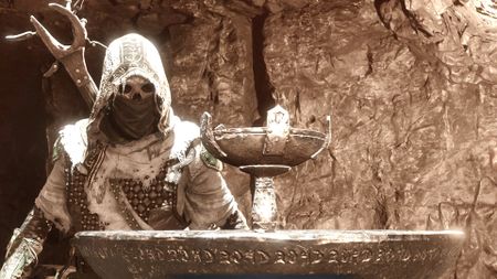 Tiel looks upon a chalice in Mortal Shell 2 which challenges him to Commune with Chaos