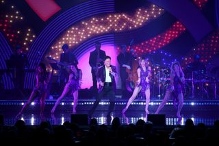 Donny Osmond is illuminated in bright purple and blue lasers and lights at his Las Vegas residency.