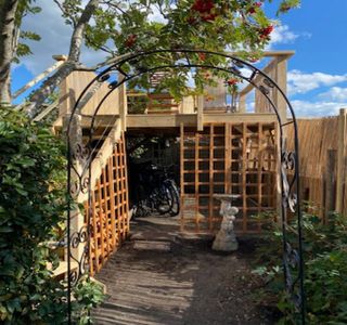 View from the garden of the tall timber frame decking