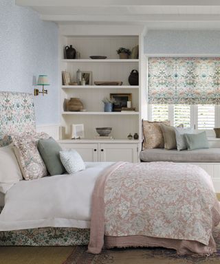 Light and bright bedroom with matching fabric used for blinds and headboard, large shelving unit, window seat bench with scatter cushions