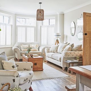 Open-plan living and dining space with squashy sofas and neutral colour palette
