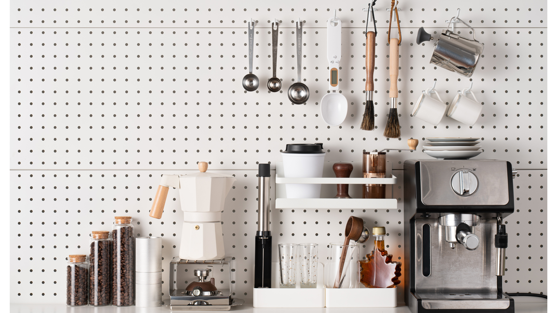 white kitchen pegboard used a splashback and kitchen storage idea combined with utensils hanging beside a coffee machine