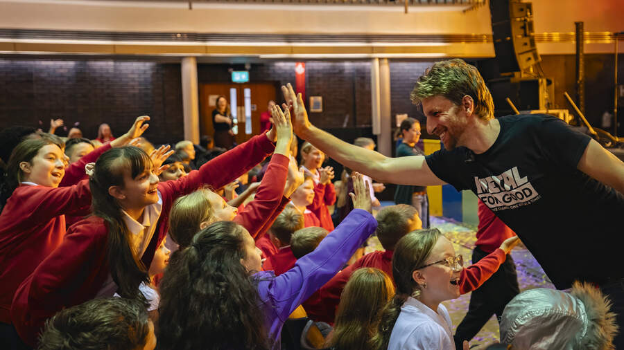 Adam Thistlethwaite high-fives audience members at the Great Hall, Lancaster
