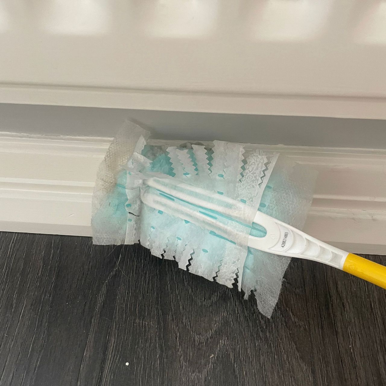 Using Flash dust magnet to dust white skirting boards