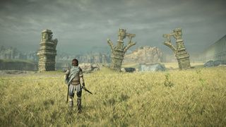 A warrior overlooking ruins on a grassy field beneath a grey sky in Shadow of the Colossus