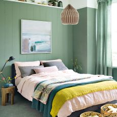 Green bedroom with pink linen bedding