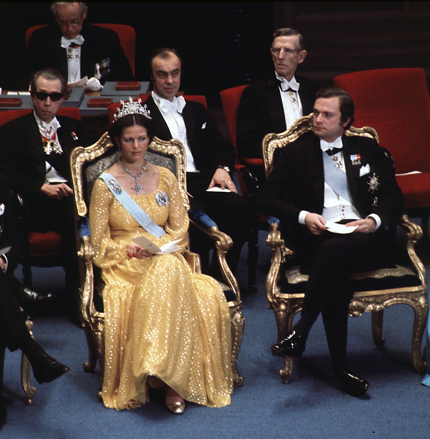 Queen Silvia wearing a yellow gown and tiara in 1976