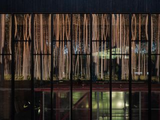 Facade reflecting the trees at The Plus Vestre factory opening
