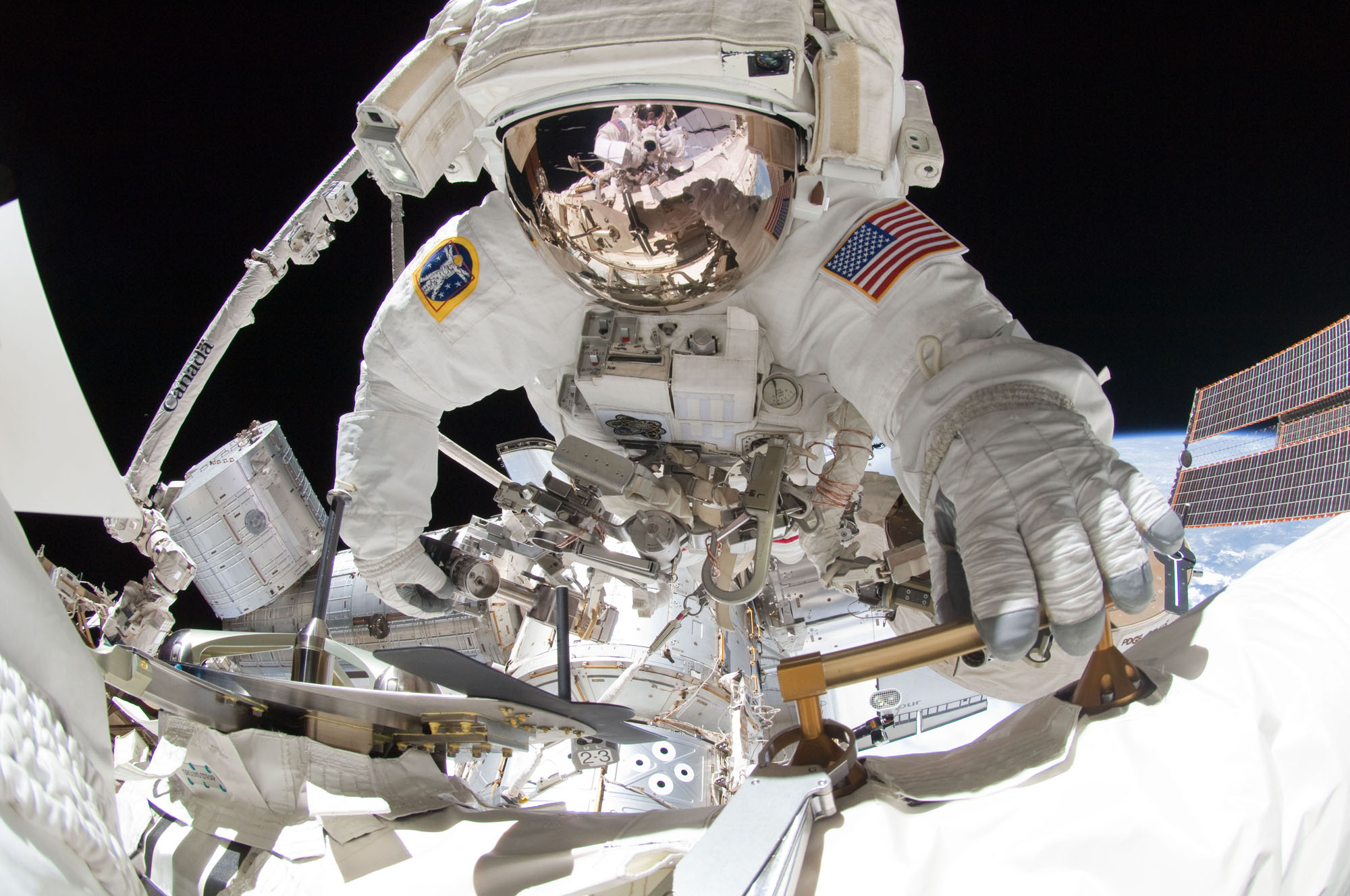 NASA astronaut Greg Chamitoff takes center stage in this amazing spacewalk photo taken by crewmate Mike Fincke (visible in the reflection on Chamitoff&#039;s spacesuit visor) using a fish-eye lens and digital camera during a May 27, 2011 excursion outside the 