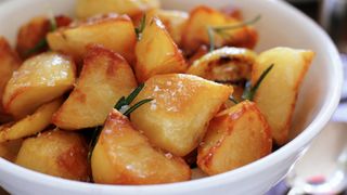 Roast potatoes with salt and rosemary ready to serve after being cooked in an air fryer