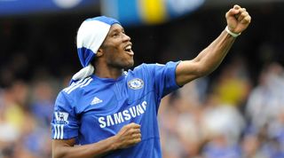 Didier Drogba celebrates Chelsea's Premier League title win in May 2010 after an 8-0 win over Wigan Athletic at Stamford Bridge.