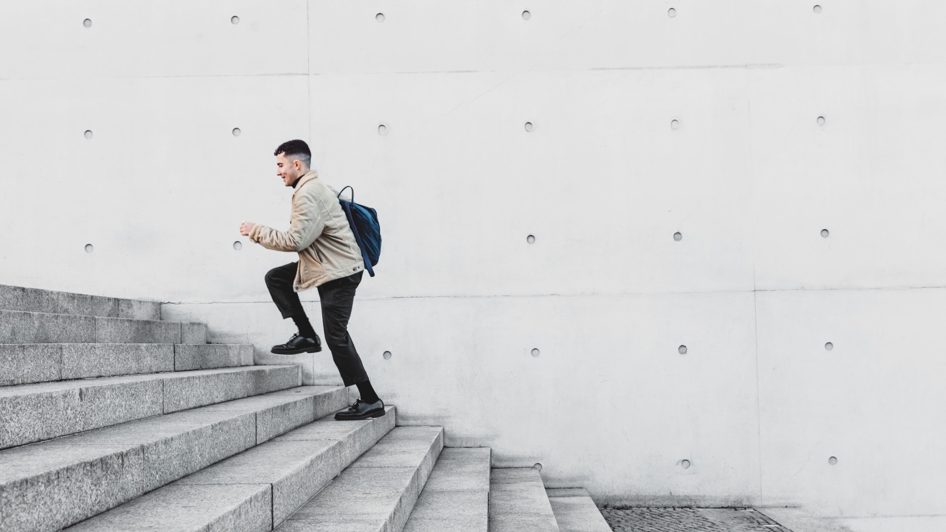 A man climbing the stairs outside