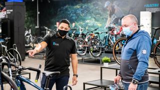 Rutland Cycling employee helps a customer to buy a bike