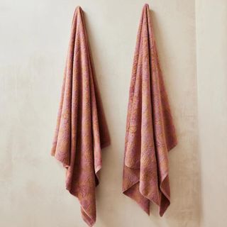 French Flax Linen Terry Bath Towel hanging from a bathroom wall.