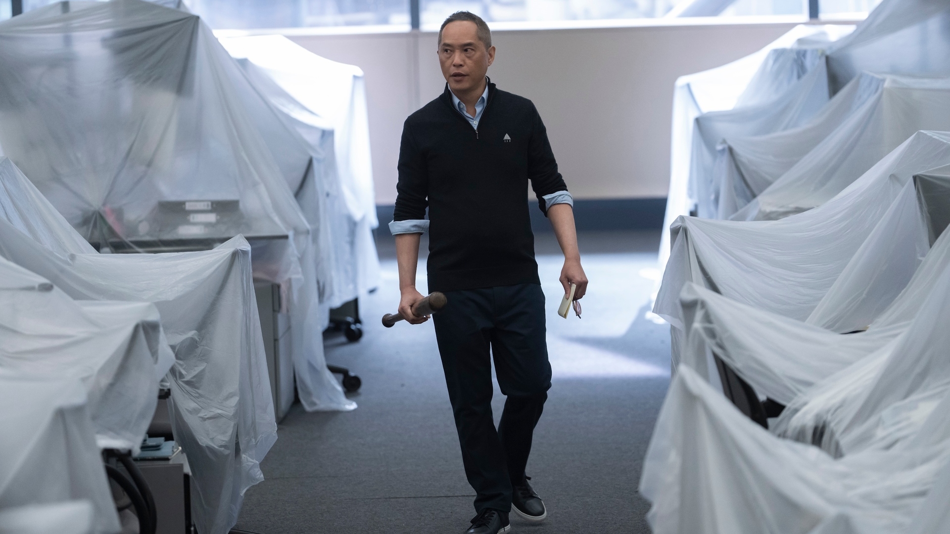 Eric walks through the covered desks in Industry season 3