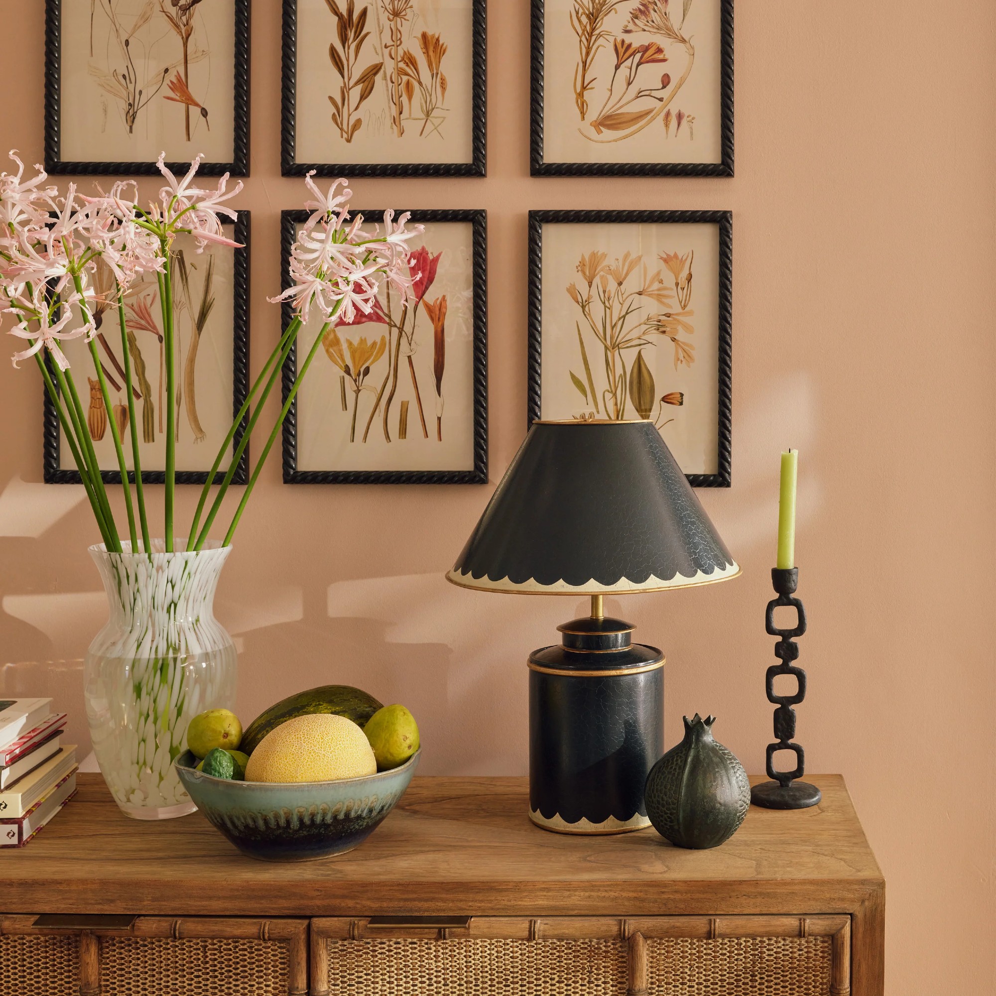 OKA Lastura Table Lamp and Shade in Air Force Blue on a sideboard with a botanical-print gallery wall behind it