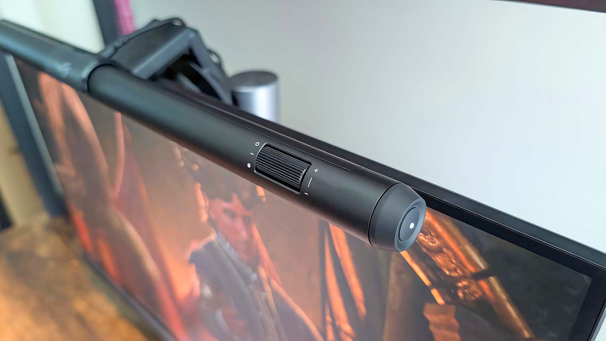 A shot of the ASUS ROG Aura Monitor Light Bar that focuses on the brightness dial and side button. 