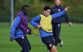 Emmanuel Frimpong and Mikel Arteta of Arsenal durting a training session at London Colney on November 5, 2013 in St Albans, England.