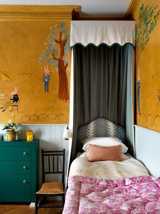 A bedroom with wall mural behind the bed