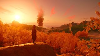 A screenshot from Ghost of Tsushima, showing a wide landscape, full of trees and hills, with the setting sun casting a red hue across the view