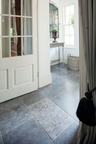 large grey stone floor tiles in a hallway