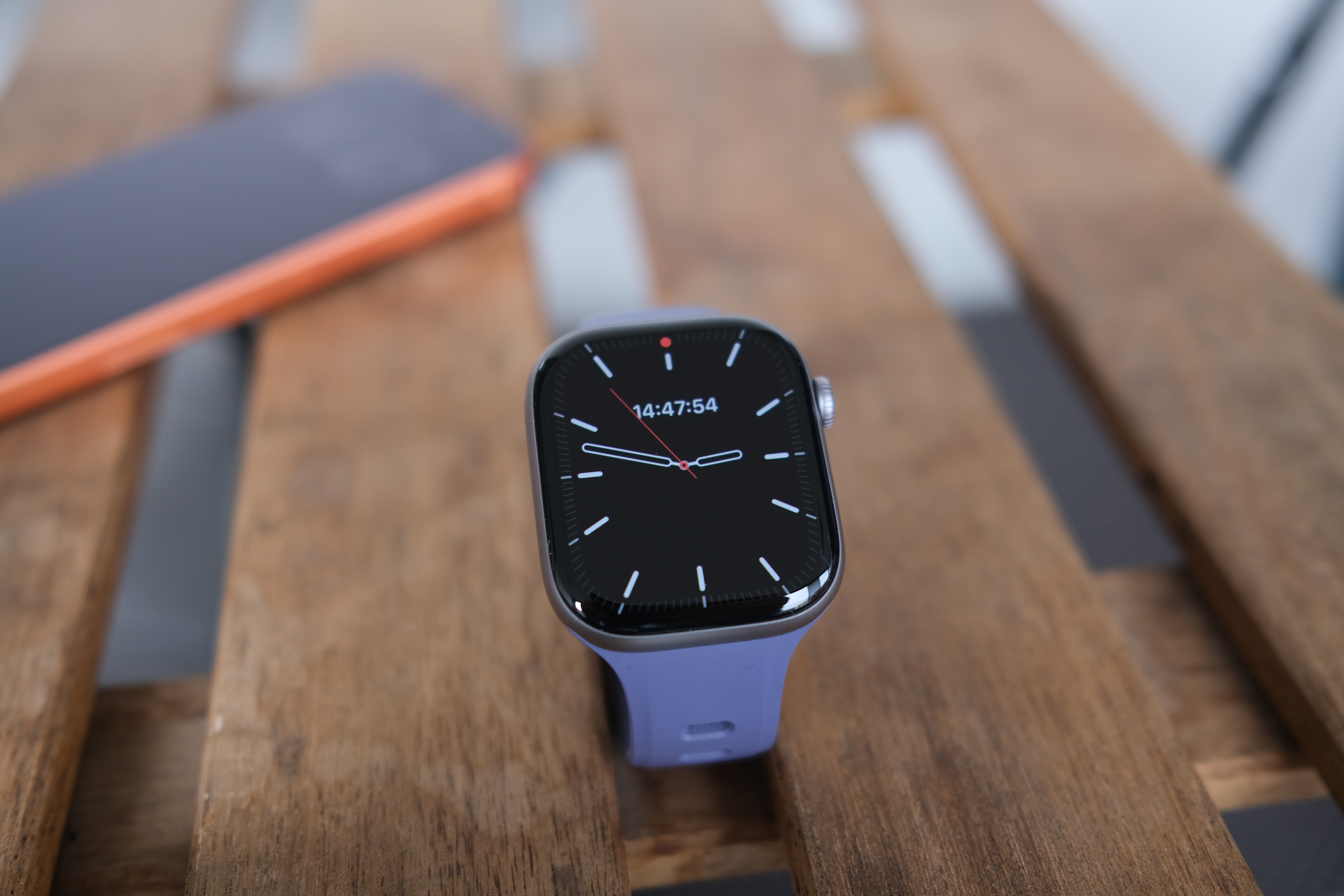 The Apple Watch Series 11 resting on a wooden table