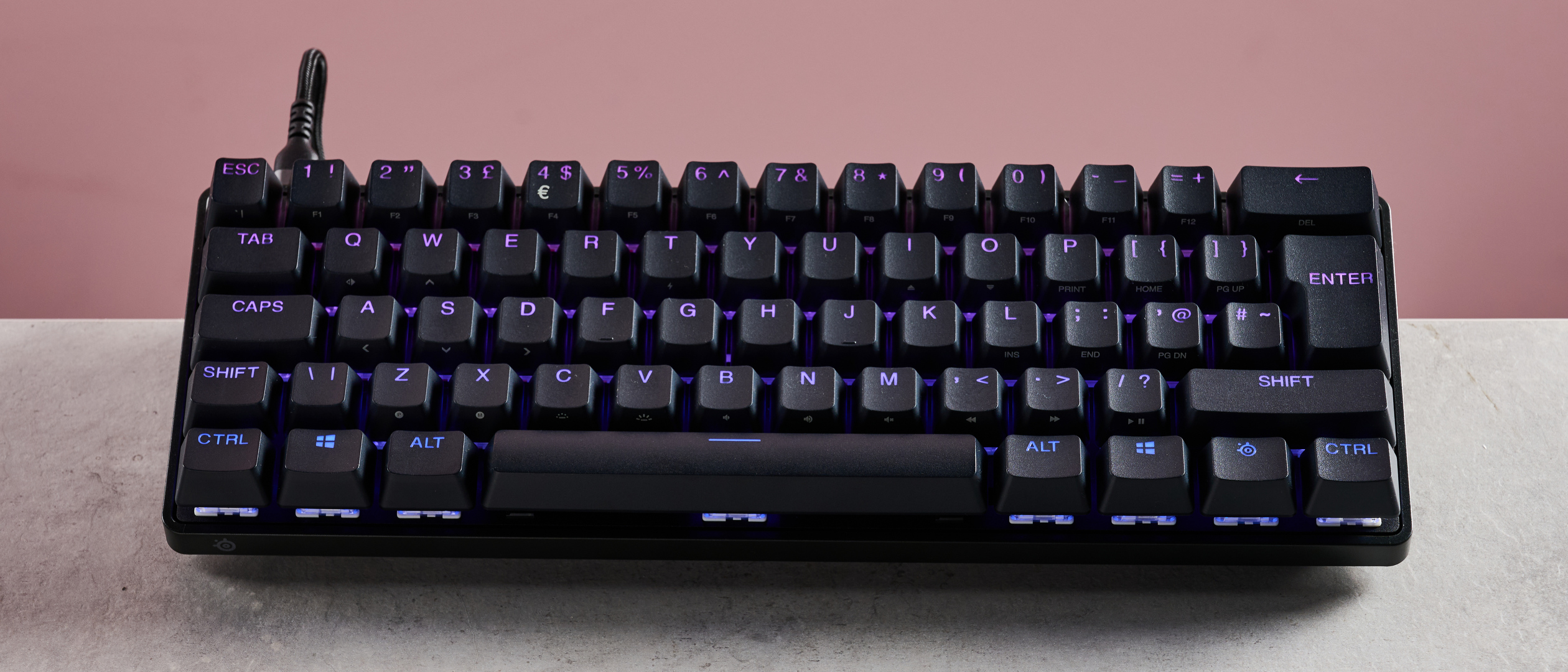SteelSeries Apex Pro Mini on desk with pink background